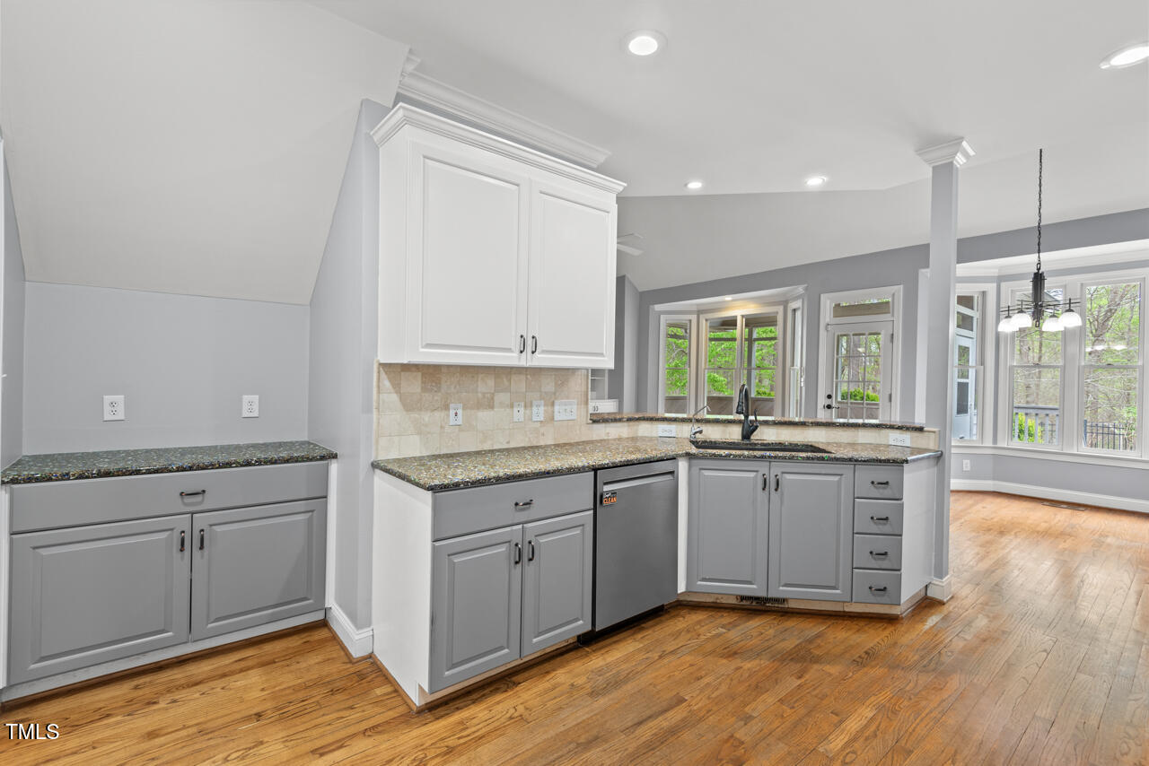 5900 Orchid Valley Road Raleigh, NC 27613 - Photo 17 of 52 a kitchen with granite countertop white cabinets and white appliances