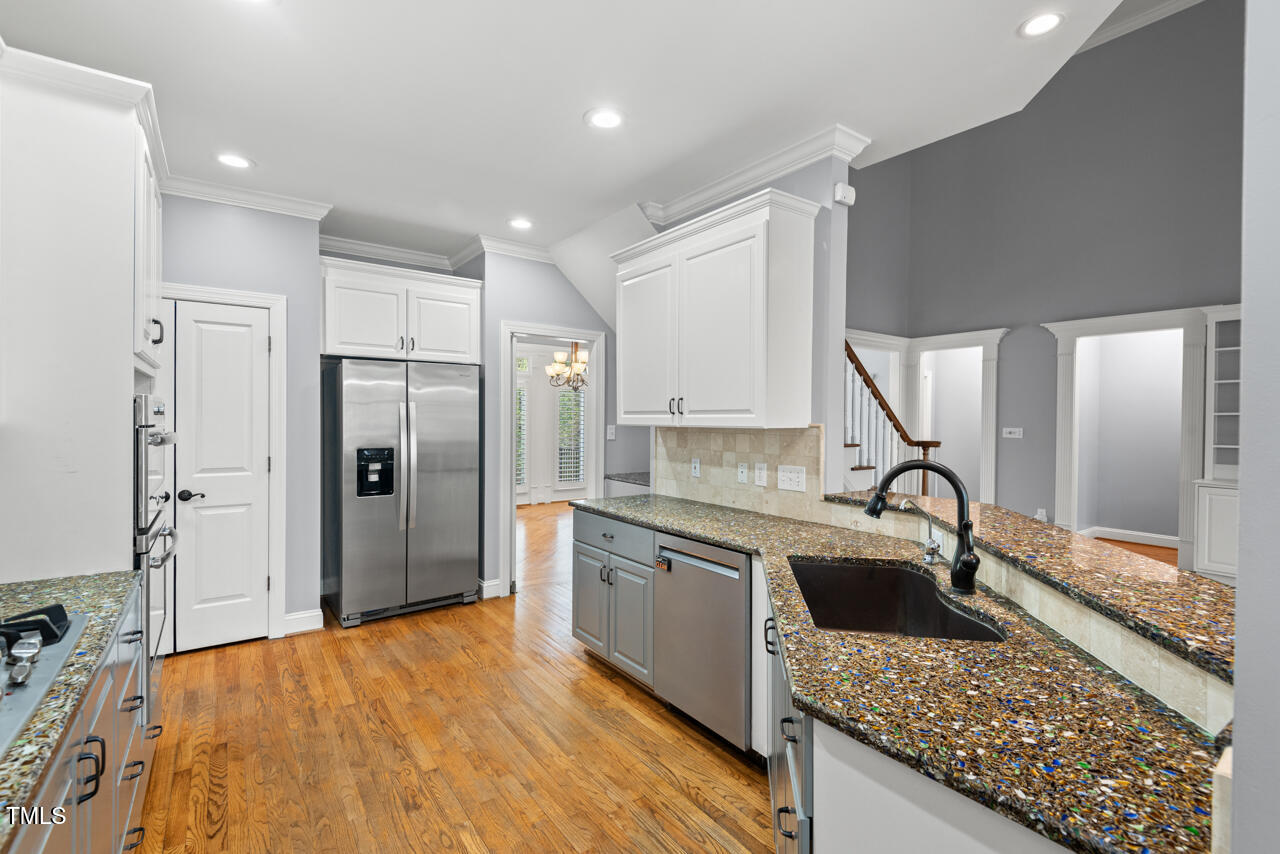 5900 Orchid Valley Road Raleigh, NC 27613 - Photo 18 of 52 a kitchen with stainless steel appliances granite countertop a sink refrigerator and cabinets