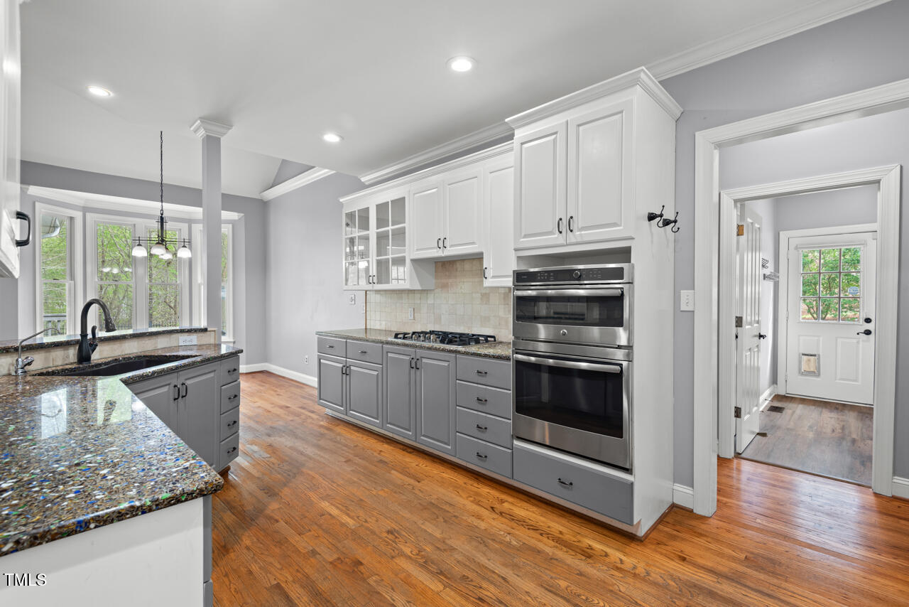 5900 Orchid Valley Road Raleigh, NC 27613 - Photo 20 of 52 a kitchen with stainless steel appliances granite countertop a stove and a sink