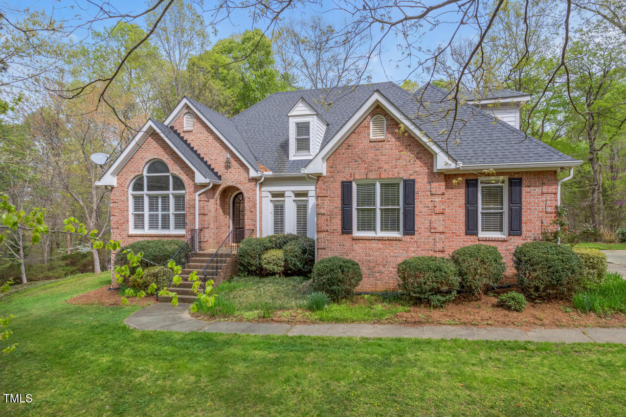 5900 Orchid Valley Road Raleigh, NC 27613 - Photo 2 of 52 a front view of a house with a yard and potted plants