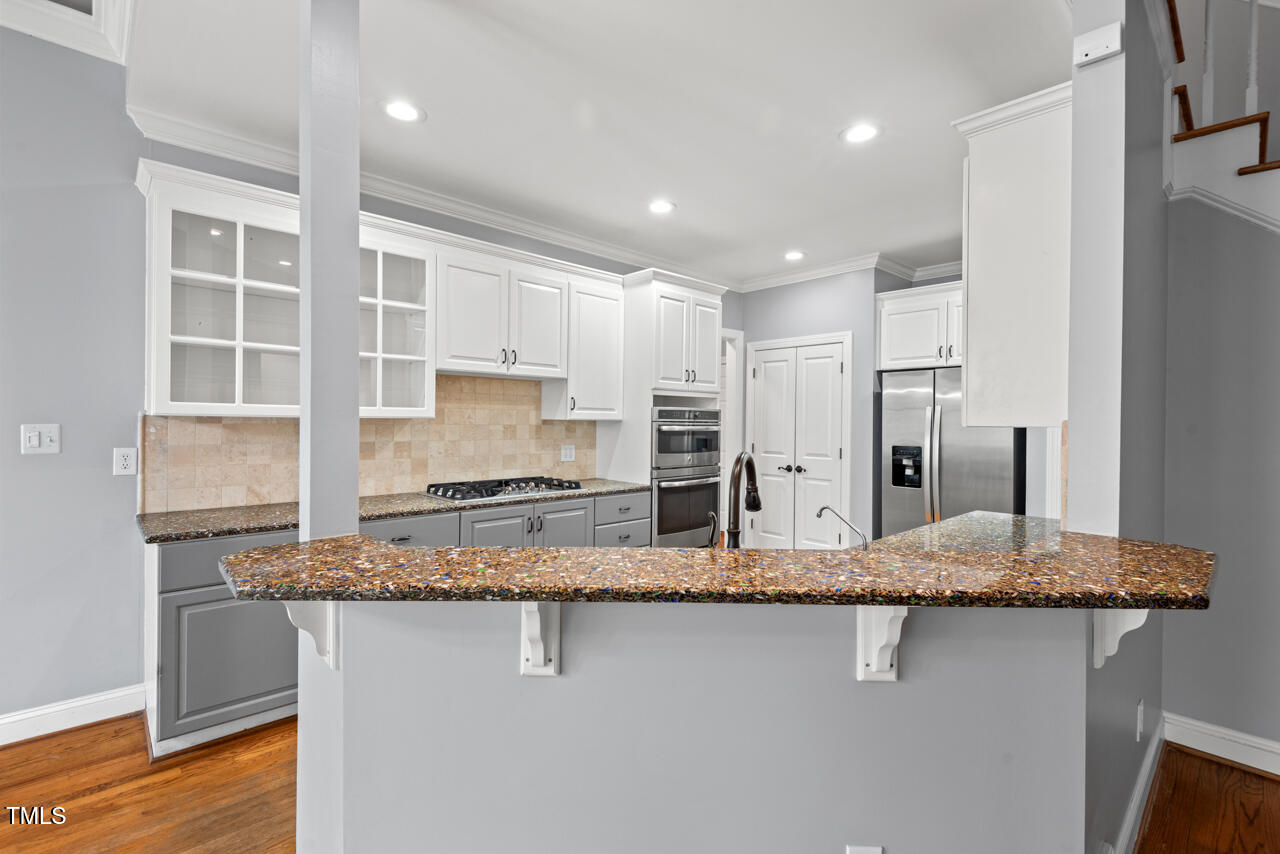 5900 Orchid Valley Road Raleigh, NC 27613 - Photo 21 of 52 a kitchen with stainless steel appliances granite countertop a sink and a refrigerator