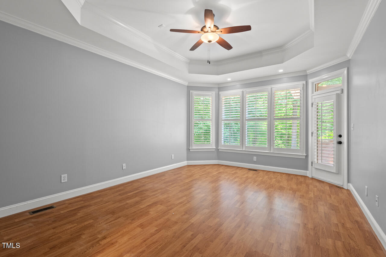 5900 Orchid Valley Road Raleigh, NC 27613 - Photo 27 of 52 a view of an empty room with a window and wooden floor