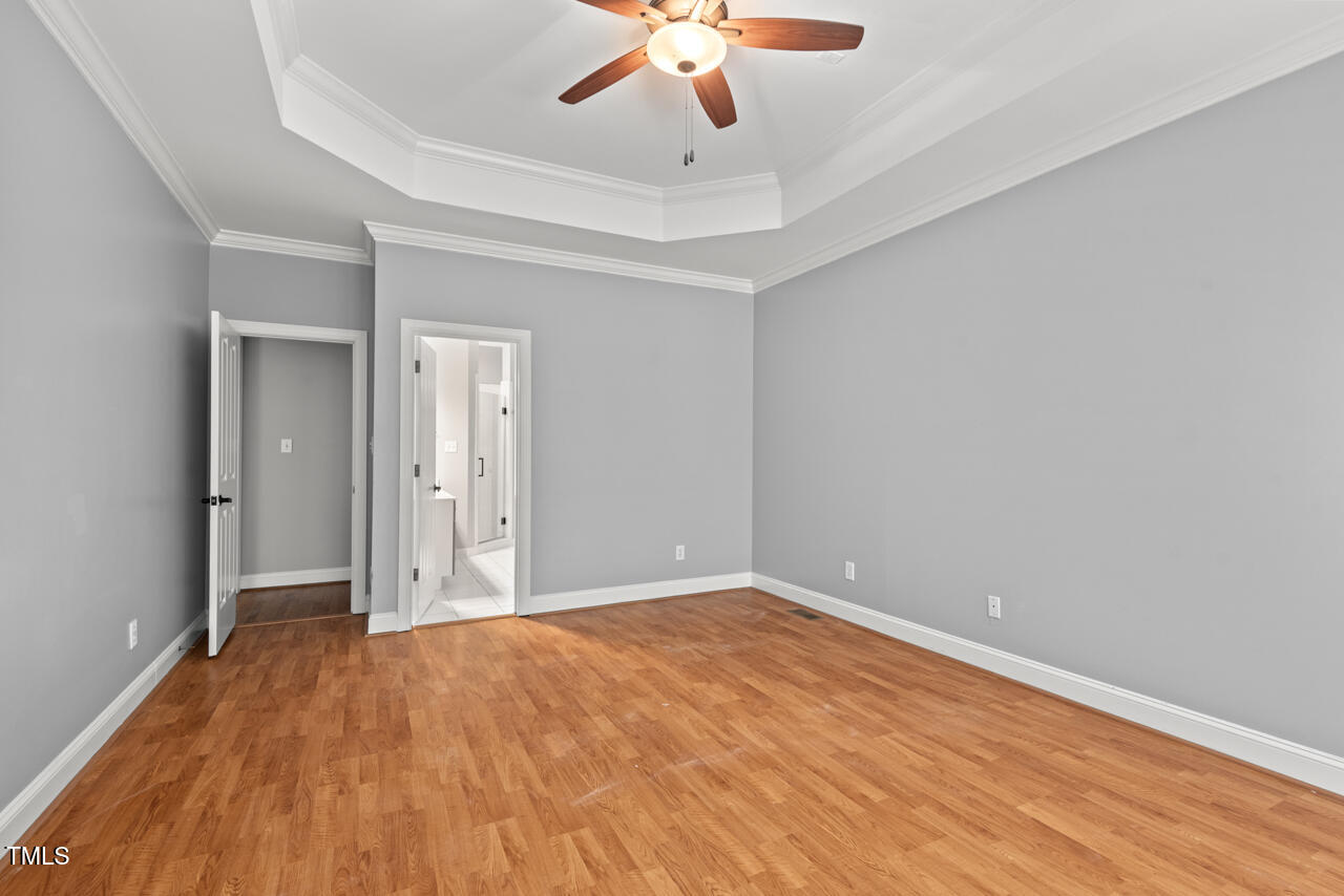 5900 Orchid Valley Road Raleigh, NC 27613 - Photo 28 of 52 an empty room with a ceiling fan and wooden floor