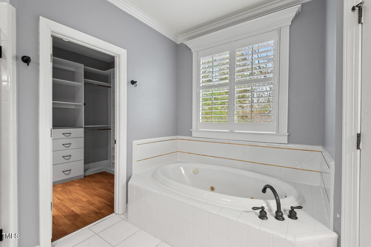 5900 Orchid Valley Road Raleigh, NC 27613 - Photo 29 of 52 a bathroom with a bathtub and a window