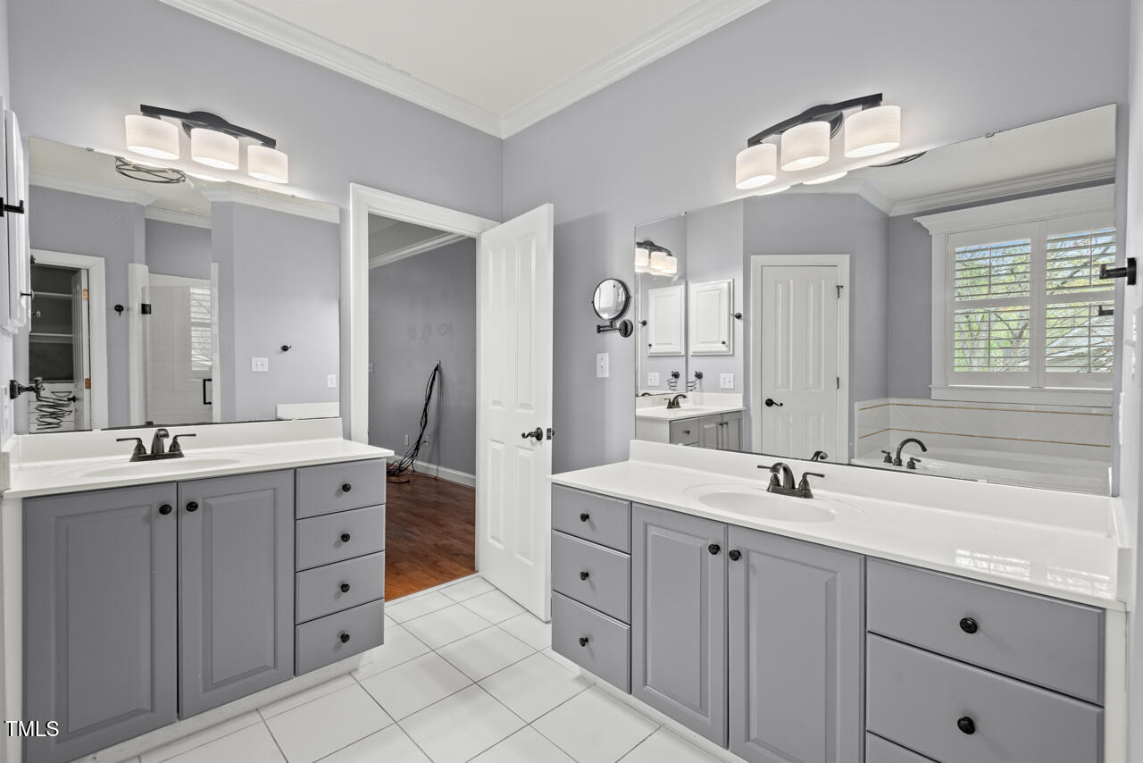 5900 Orchid Valley Road Raleigh, NC 27613 - Photo 30 of 52 a spacious bathroom with double sink and a mirror