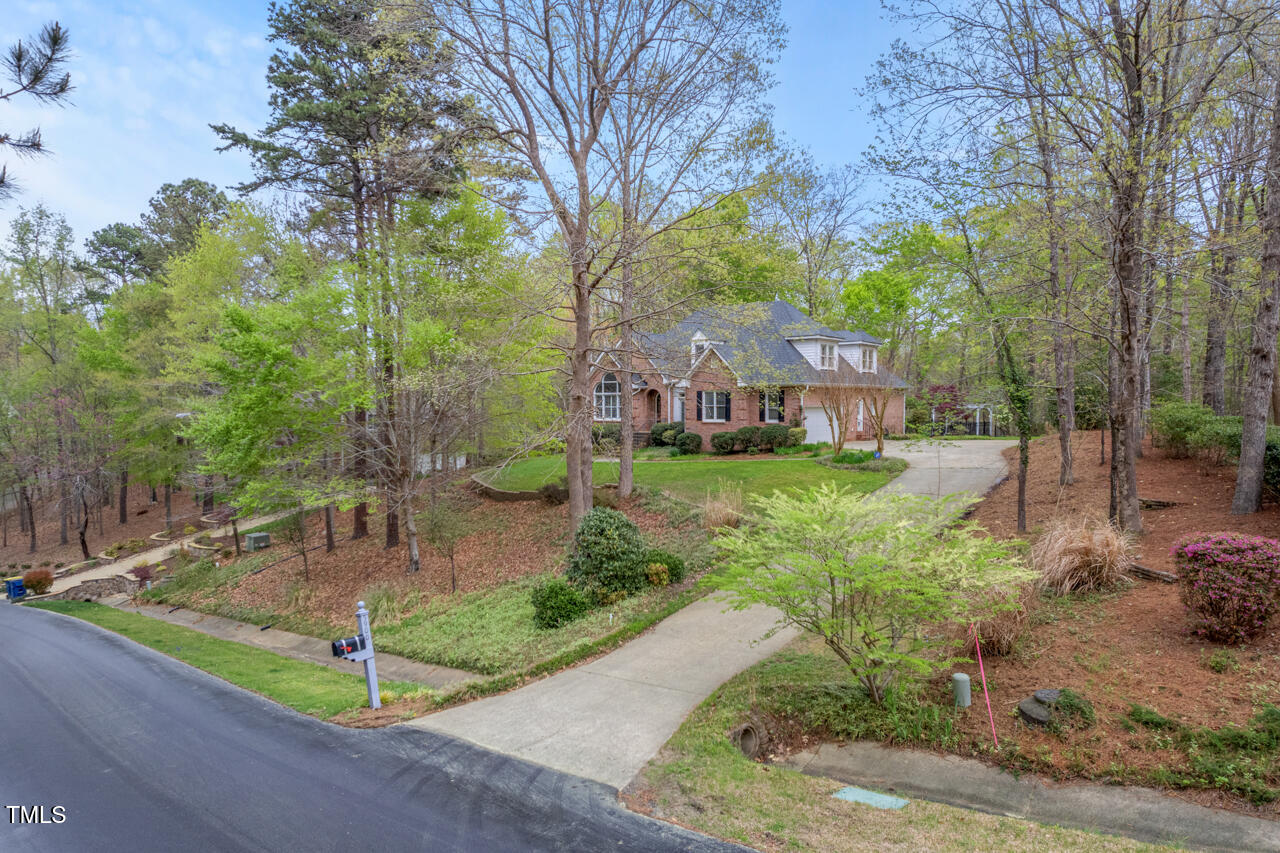 5900 Orchid Valley Road Raleigh, NC 27613 - Photo 3 of 52 a front view of a house with garden