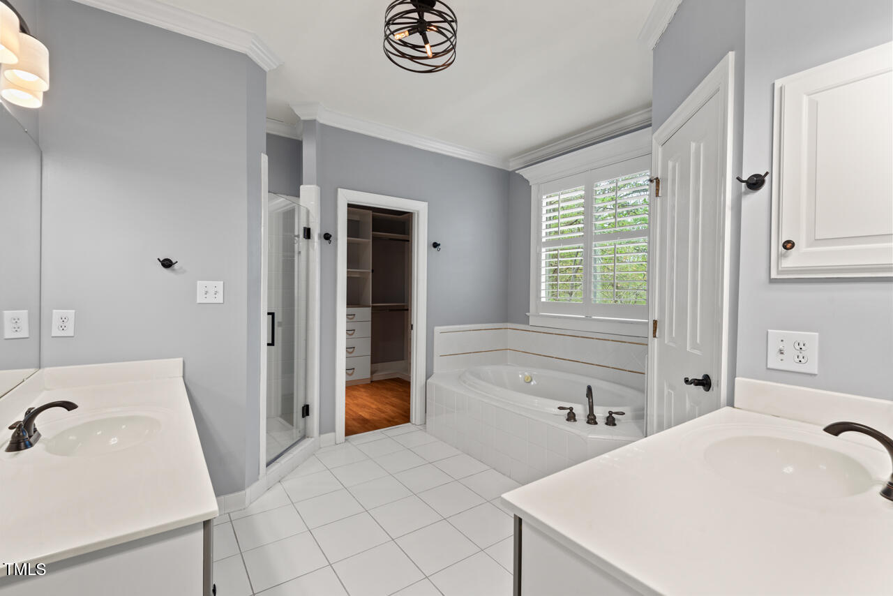 5900 Orchid Valley Road Raleigh, NC 27613 - Photo 31 of 52 a spacious bathroom with a tub sink and mirror