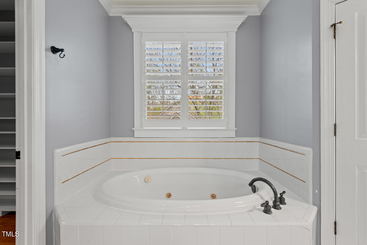 5900 Orchid Valley Road Raleigh, NC 27613 - Photo 32 of 52 a white bath tub sitting next to a window