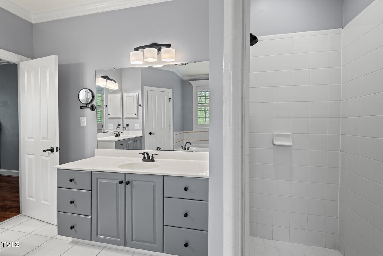 5900 Orchid Valley Road Raleigh, NC 27613 - Photo 33 of 52 a bathroom with a double vanity sink and a mirror