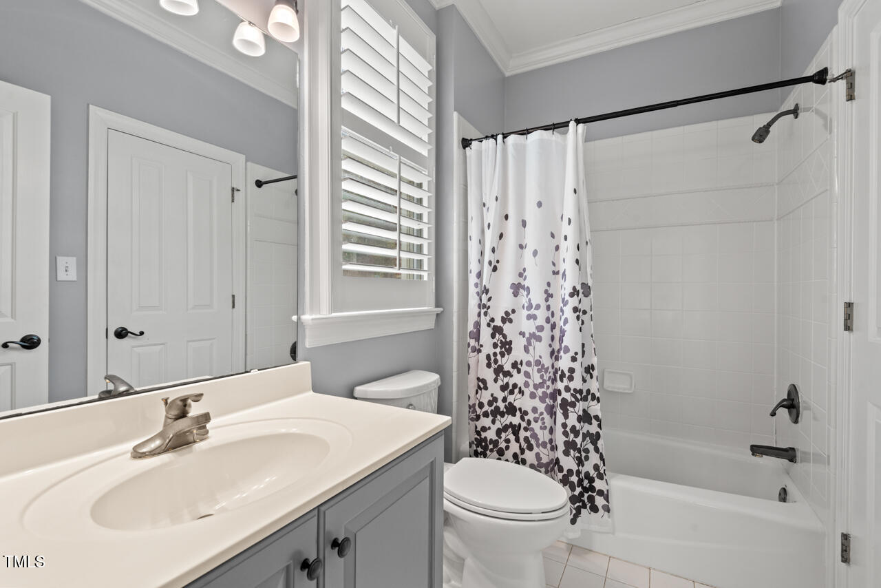 5900 Orchid Valley Road Raleigh, NC 27613 - Photo 38 of 52 a bathroom with a sink a toilet and shower curtain