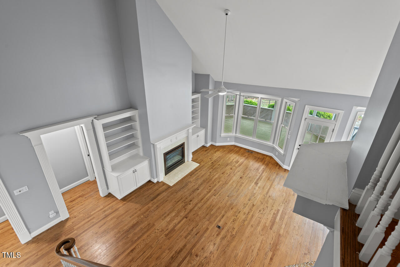 5900 Orchid Valley Road Raleigh, NC 27613 - Photo 40 of 52 a view of an empty room with wooden floor and windows