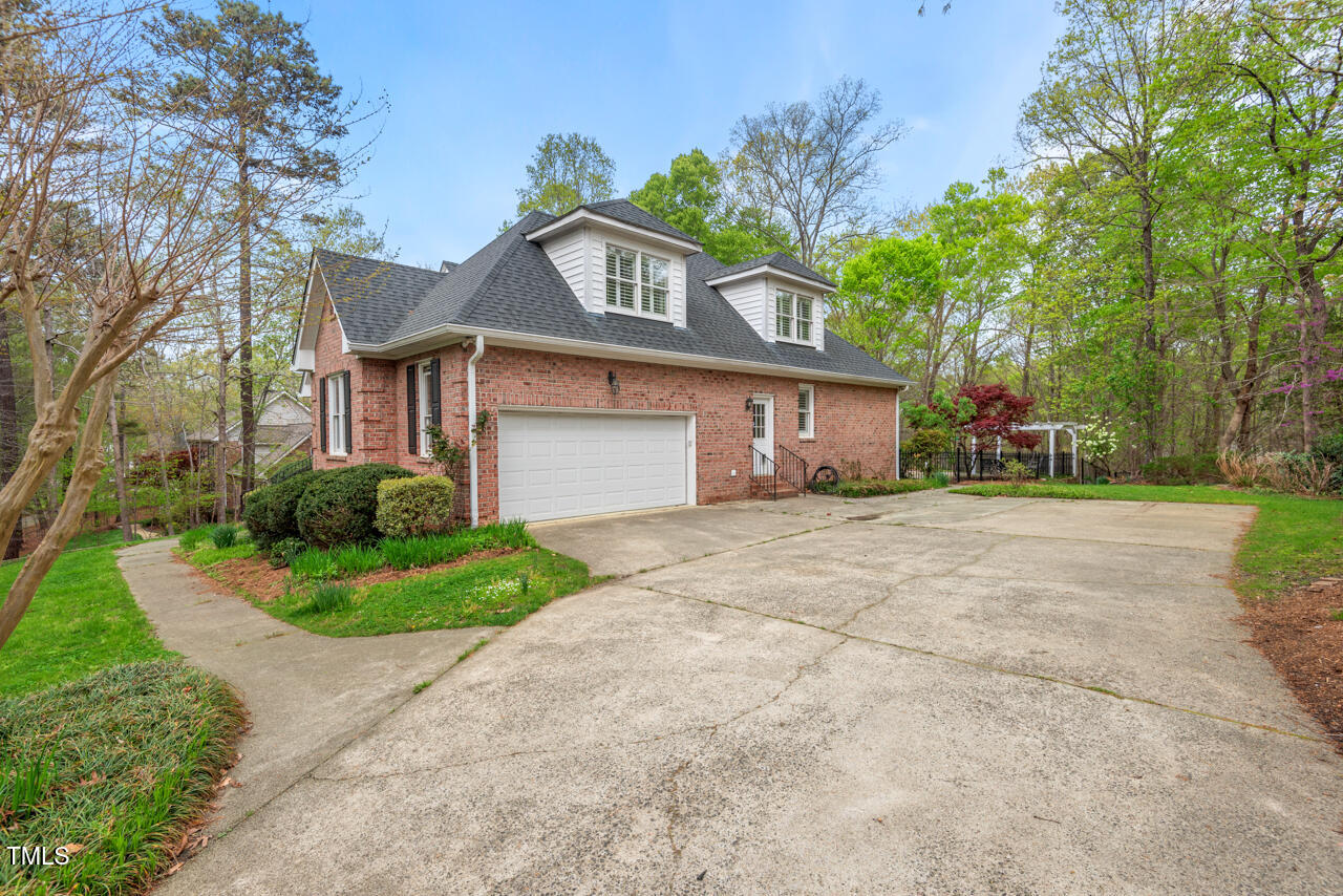 5900 Orchid Valley Road Raleigh, NC 27613 - Photo 4 of 52 a front view of a house with a yard and a garage