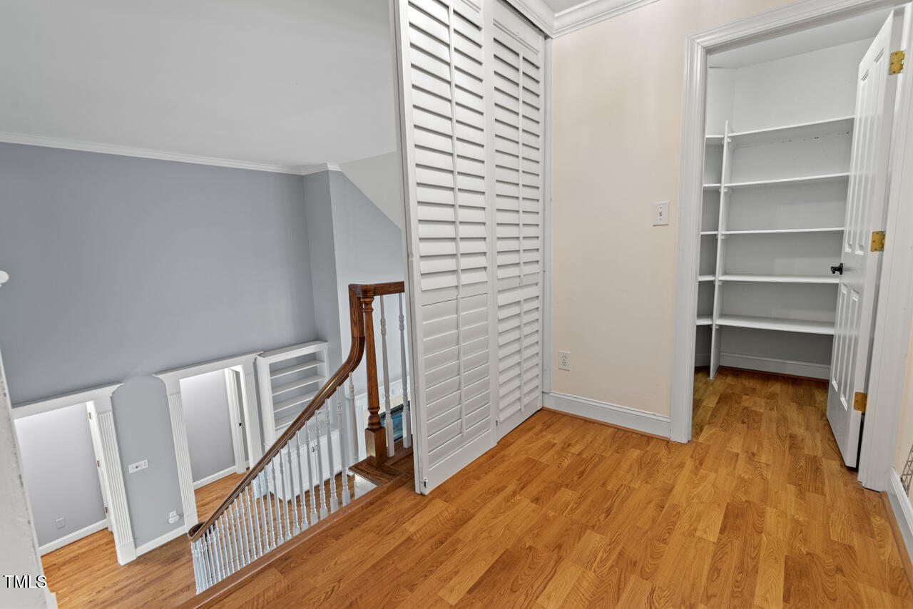 5900 Orchid Valley Road Raleigh, NC 27613 - Photo 41 of 52 a view of an empty room with wooden floor and stairs