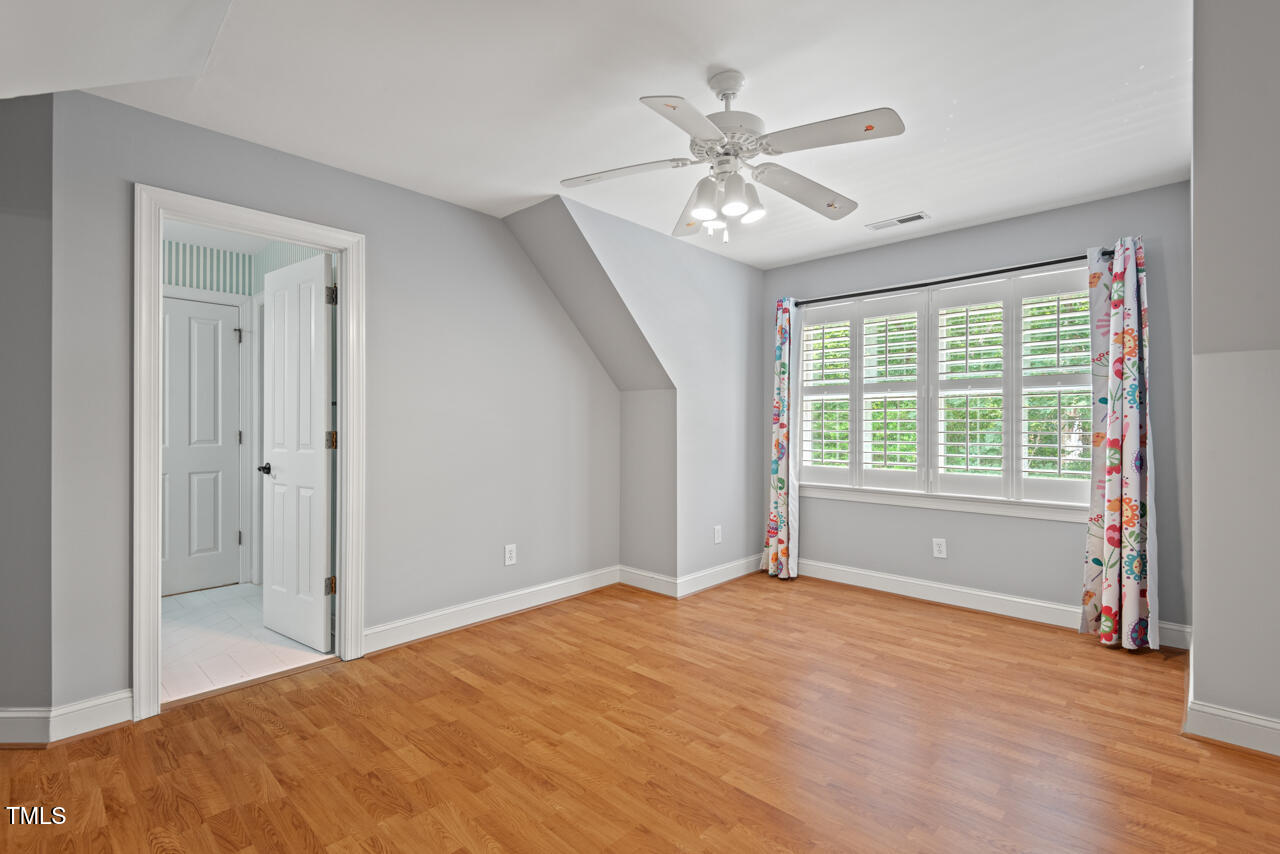 5900 Orchid Valley Road Raleigh, NC 27613 - Photo 42 of 52 a view of empty room with wooden floor and fan