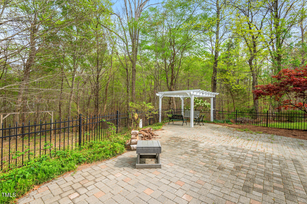 5900 Orchid Valley Road Raleigh, NC 27613 - Photo 50 of 52 a backyard of a house with table and chairs