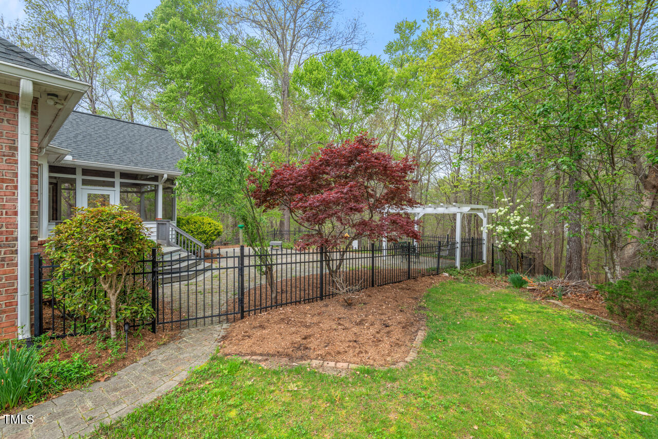 5900 Orchid Valley Road Raleigh, NC 27613 - Photo 51 of 52 a view of a backyard with a trees and plants