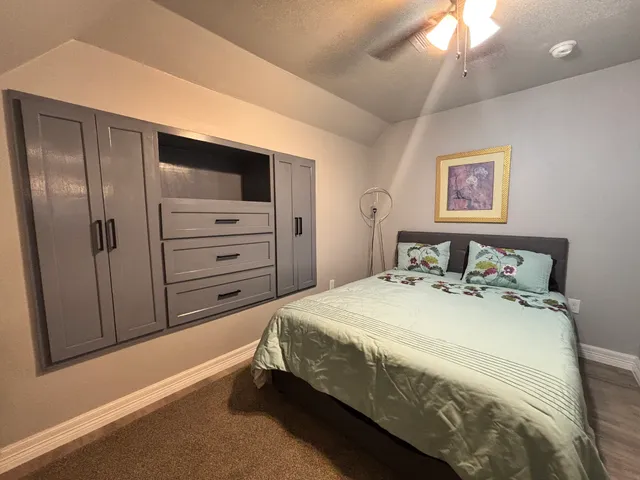 a bedroom with a bed and a dresser