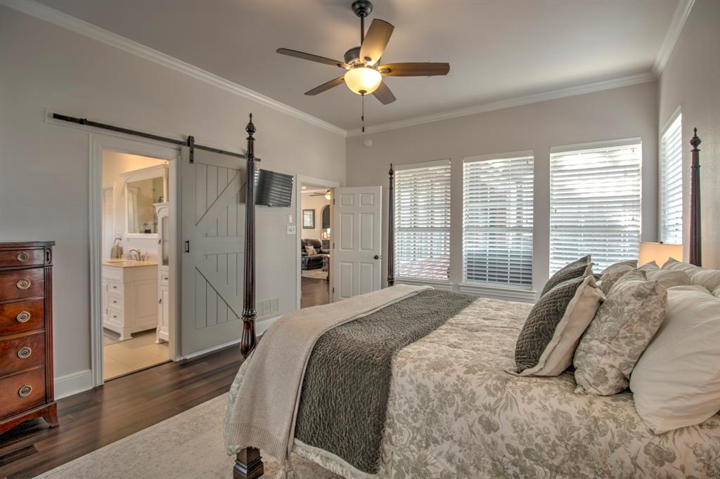 4275 Old Thomas Road Aubrey, TX 76227 - Photo 16 of 31 Master bedroom with view of entry into the Master bathroom, featuring a sliding barn door.