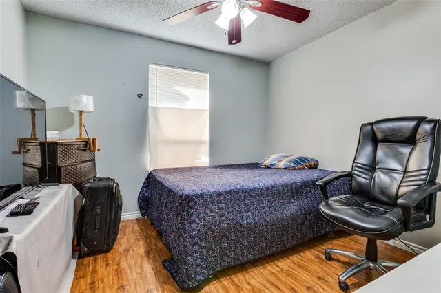 a bedroom with a bed and a lounge chair