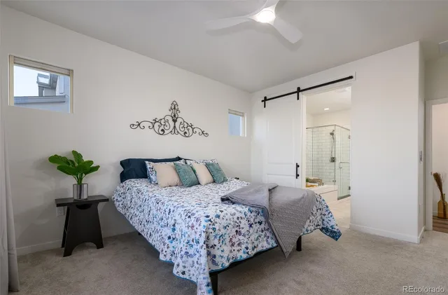 a bedroom with a bed and a potted plant