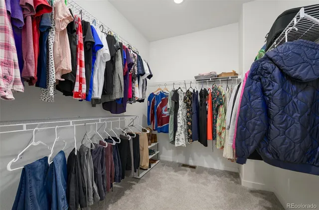 a view of walk in closet with clothes