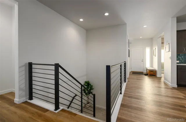 a view of a hallway with wooden floor