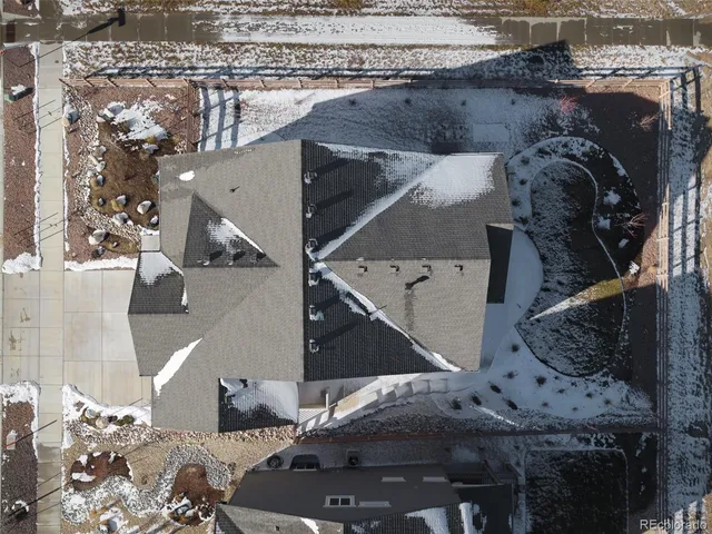 an aerial view of a house with a yard