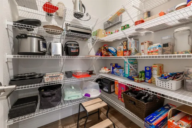a kitchen with lots of clutter and stainless steel appliances