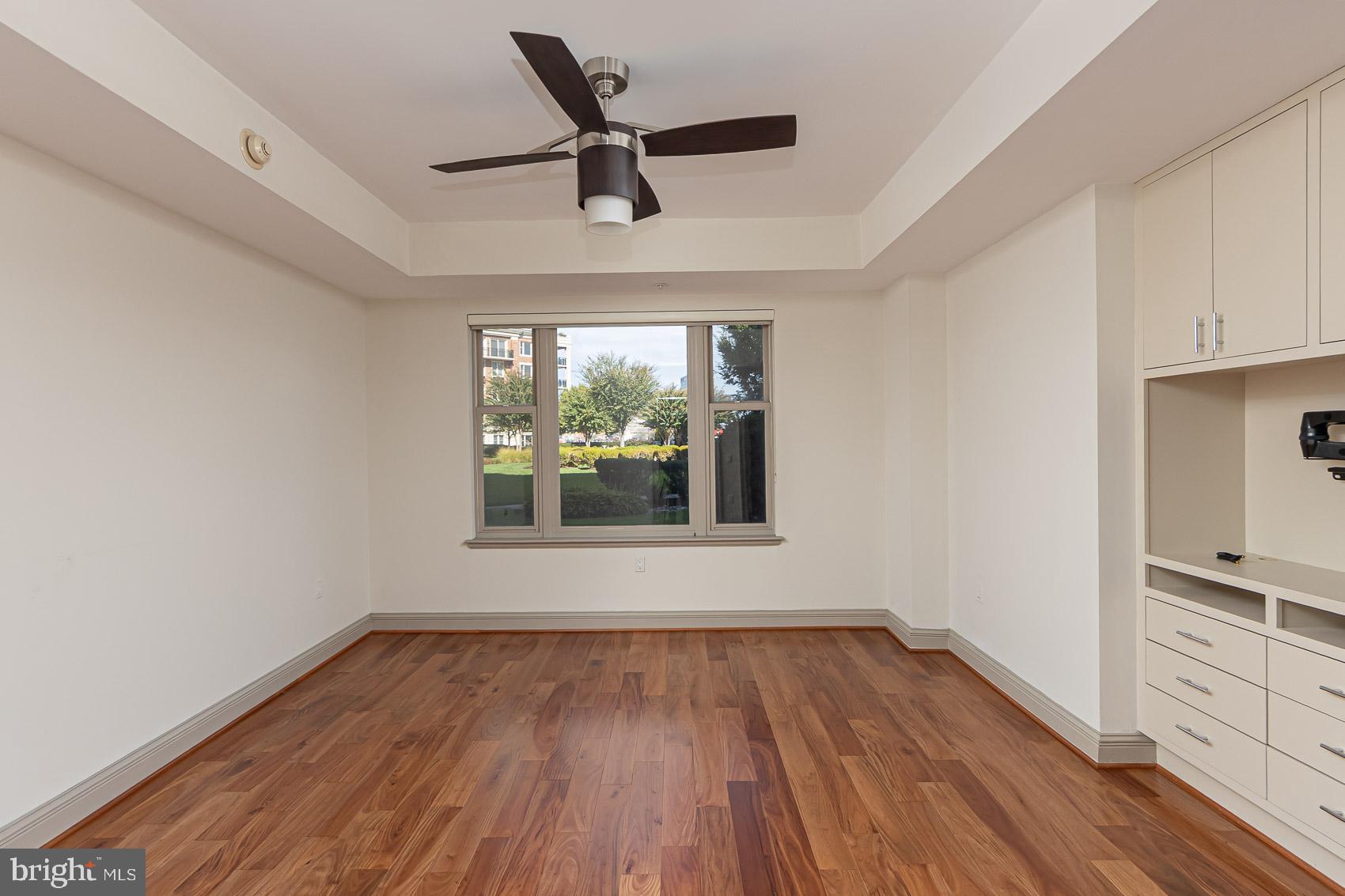 801 Key Highway, Unit 153 Baltimore, MD 21230 - Photo 18 of 40 a view of empty room with wooden floor and fan
