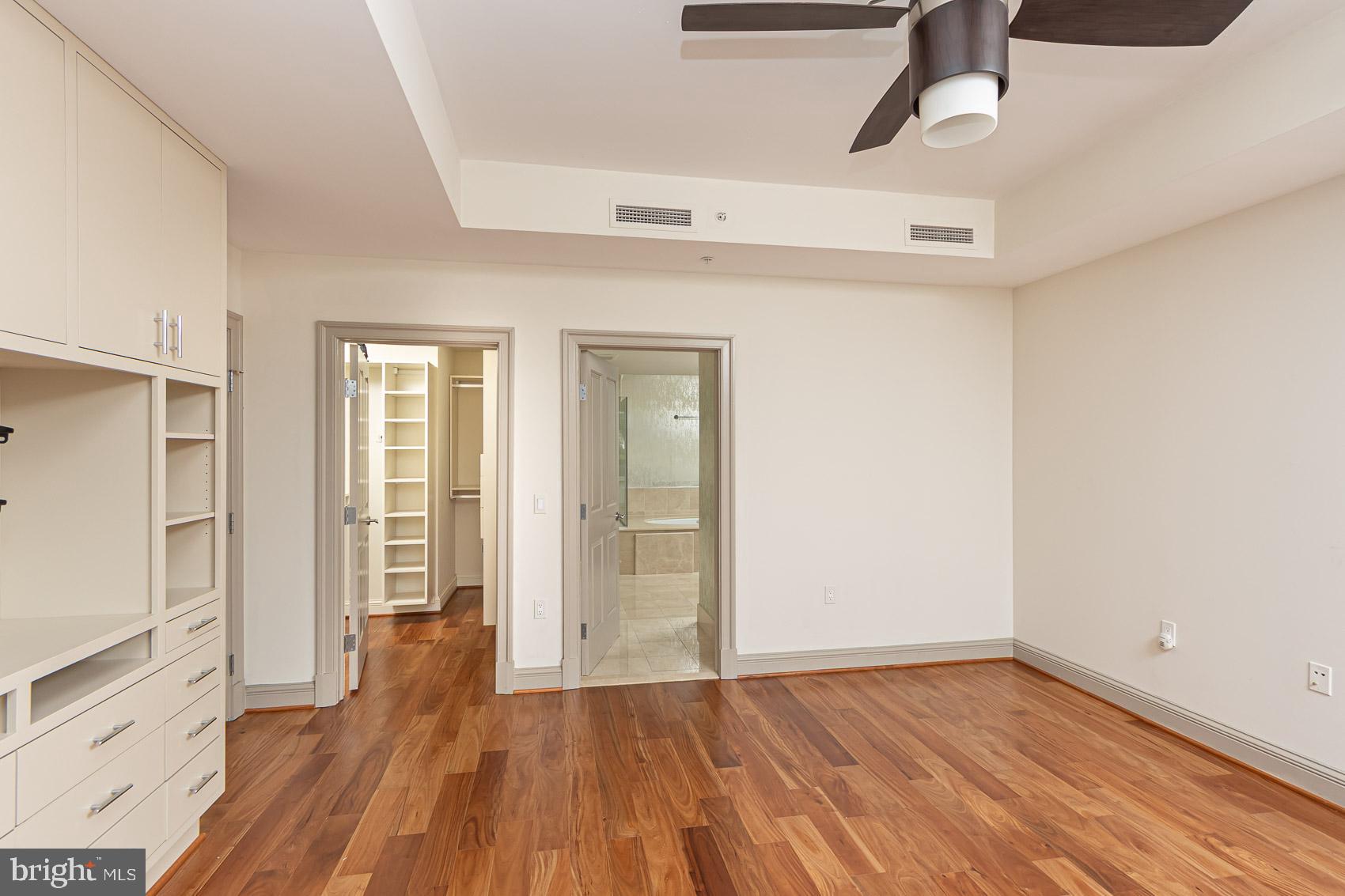 801 Key Highway, Unit 153 Baltimore, MD 21230 - Photo 20 of 40 a view of an empty room with wooden floor and a window
