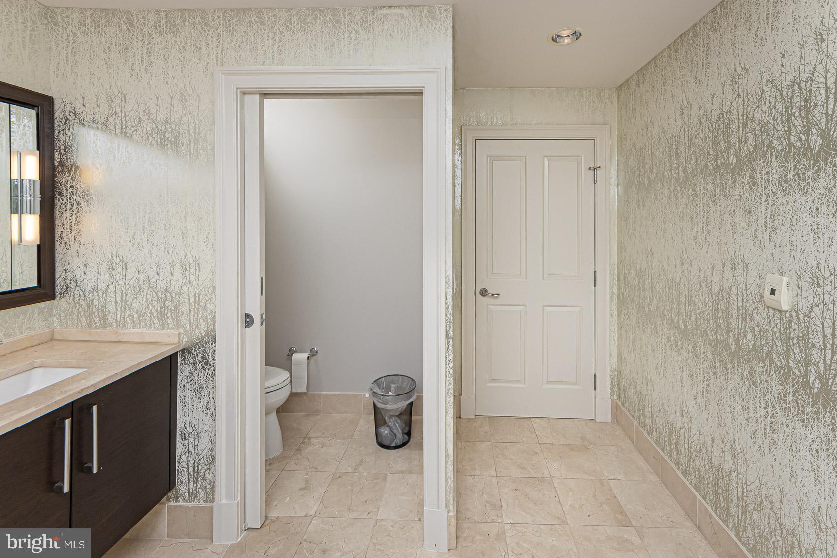 801 Key Highway, Unit 153 Baltimore, MD 21230 - Photo 26 of 40 a bathroom with a sink a toilet and shower