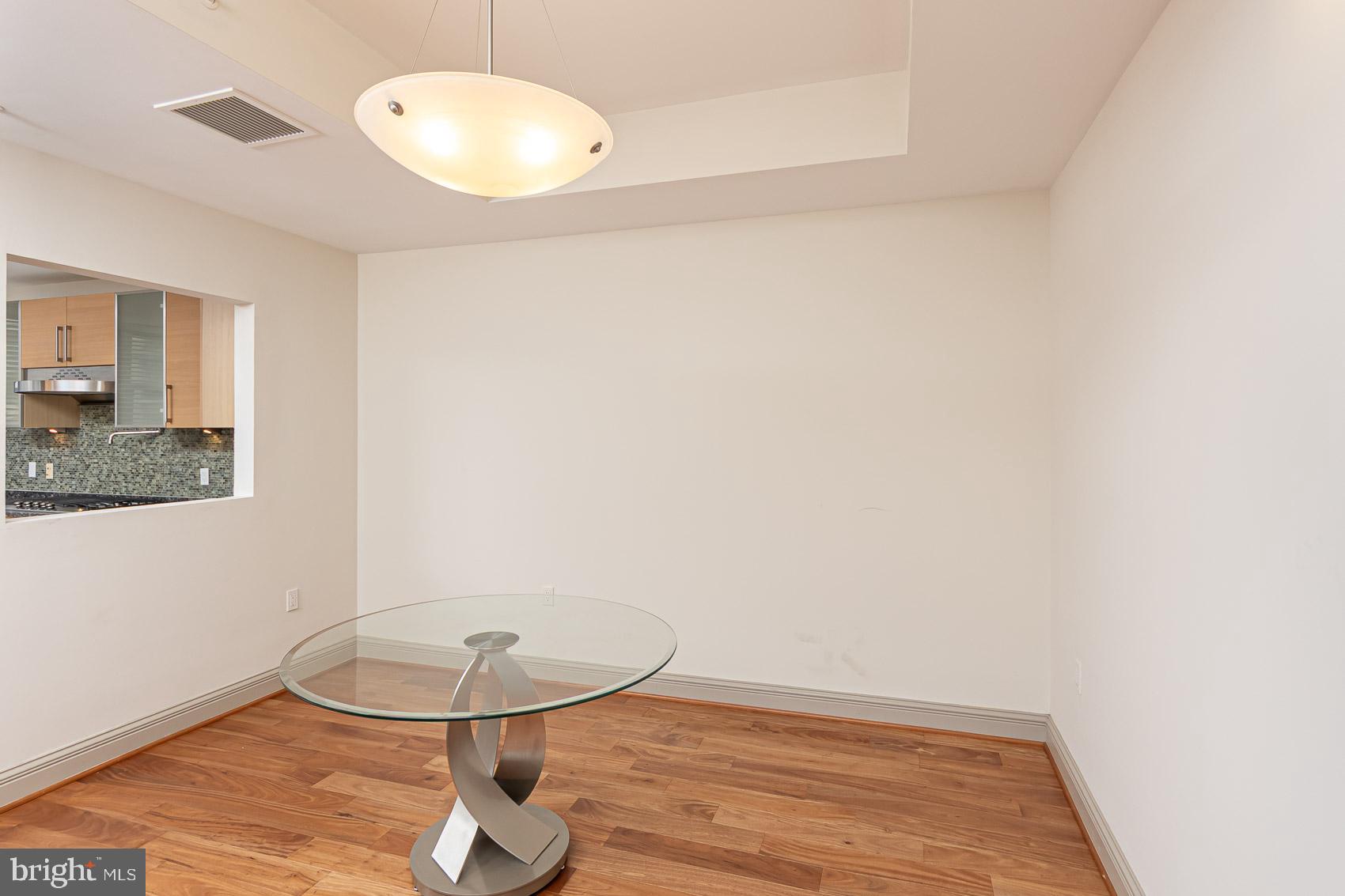 801 Key Highway, Unit 153 Baltimore, MD 21230 - Photo 9 of 40 a view of a room with wooden floor and glass door