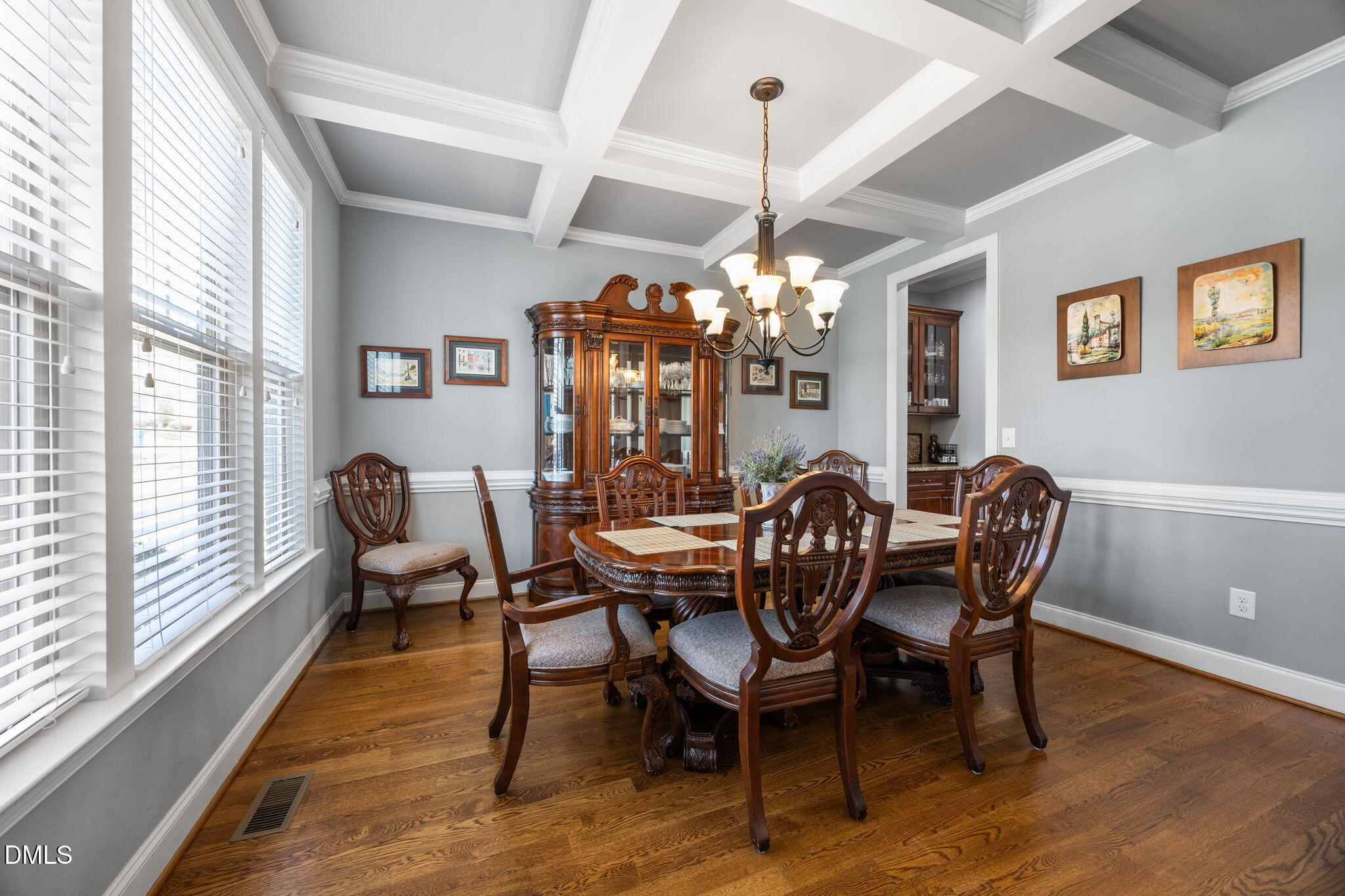 4603 Brighton Ridge Drive Apex, NC 27539 - Photo 10 of 69 a dining room with furniture a chandelier and wooden floor