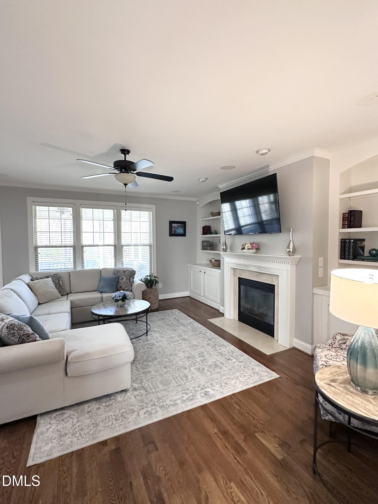 4603 Brighton Ridge Drive Apex, NC 27539 - Photo 12 of 69 a living room with furniture a fireplace and a flat screen tv