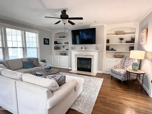 a living room with furniture a fireplace and a flat screen tv