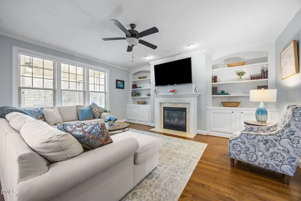 a living room with furniture kitchen view and a chandelier