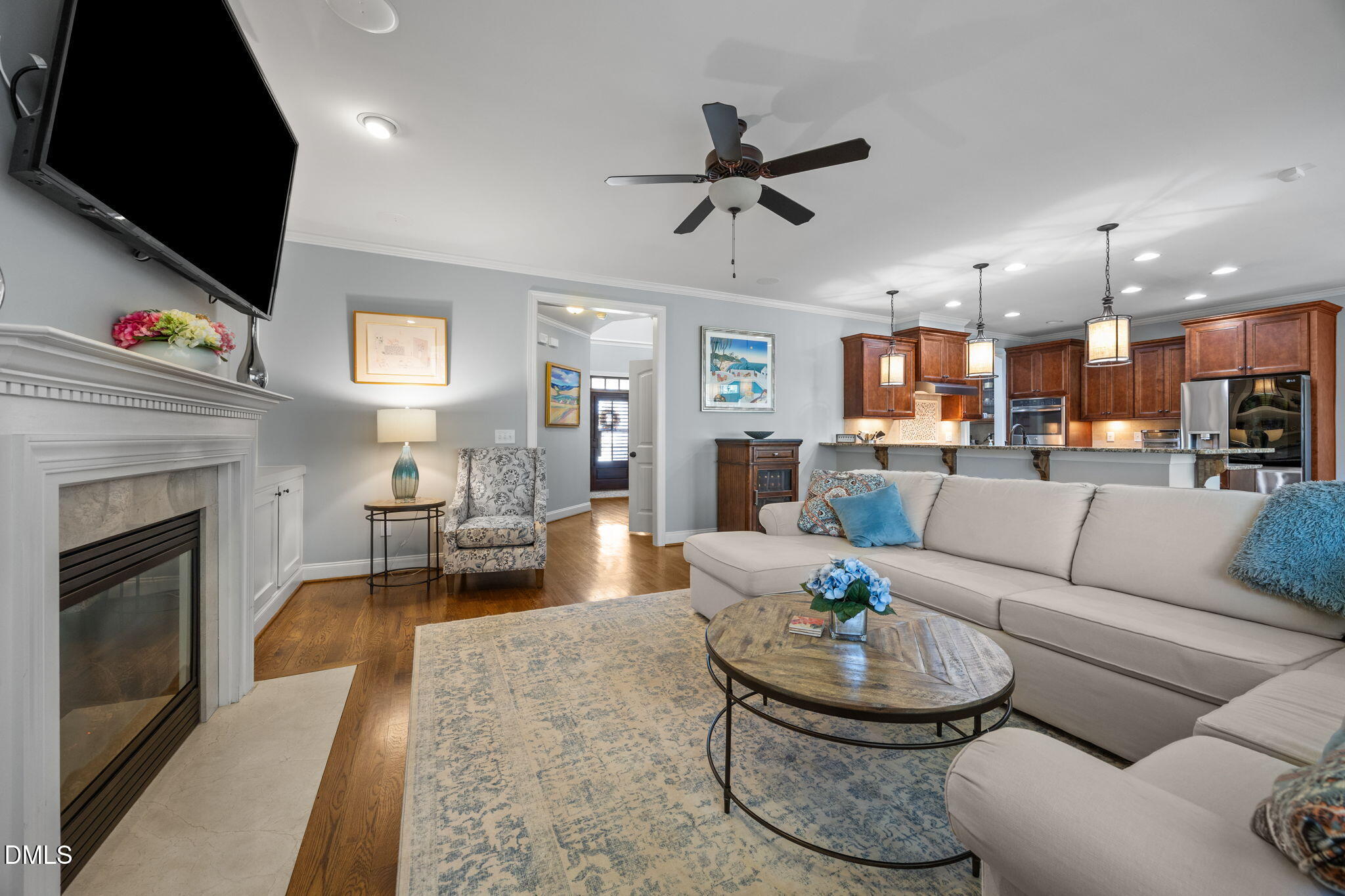 4603 Brighton Ridge Drive Apex, NC 27539 - Photo 15 of 69 a living room with furniture a fireplace and a flat screen tv