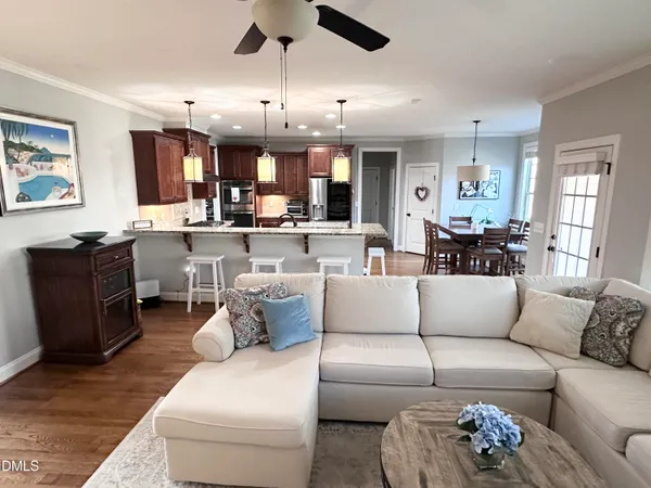 a kitchen with stainless steel appliances granite countertop a sink a stove and a wooden floors