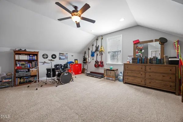 a spacious bedroom with a bed and a window