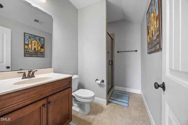a bathroom with a toilet a sink and shower