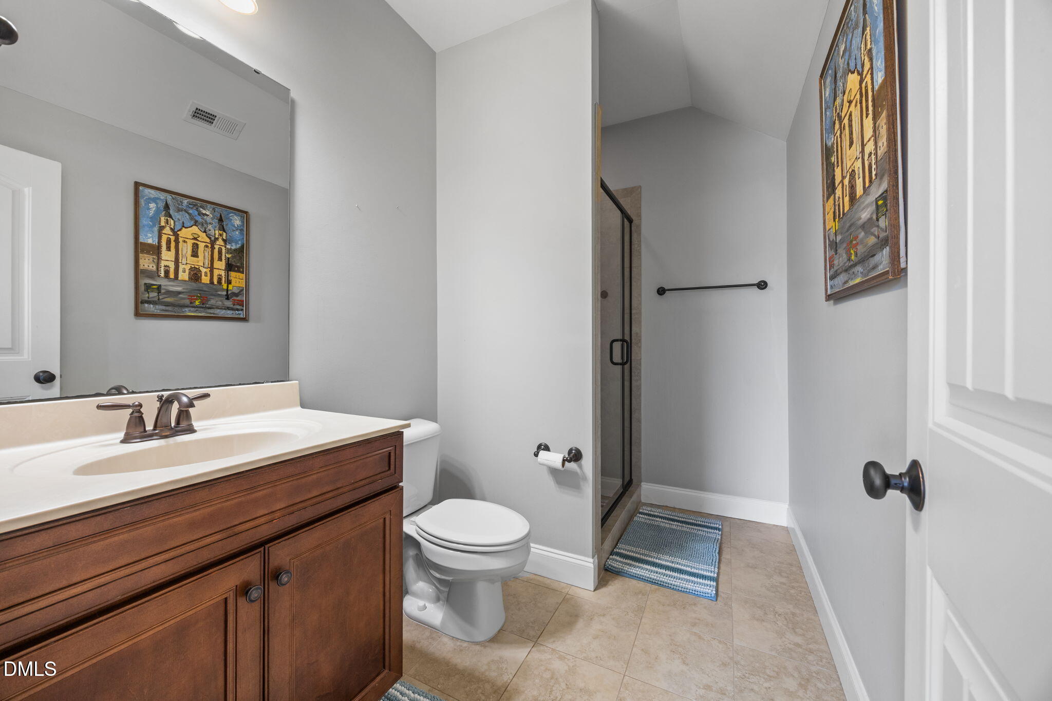 4603 Brighton Ridge Drive Apex, NC 27539 - Photo 39 of 69 a bathroom with a toilet sink and mirror