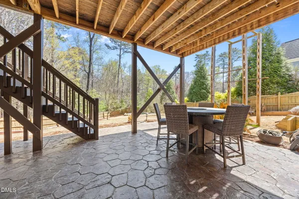 a view of a house with wooden deck and furniture