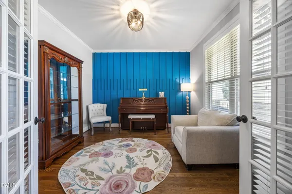 a dining room with furniture a chandelier and wooden floor