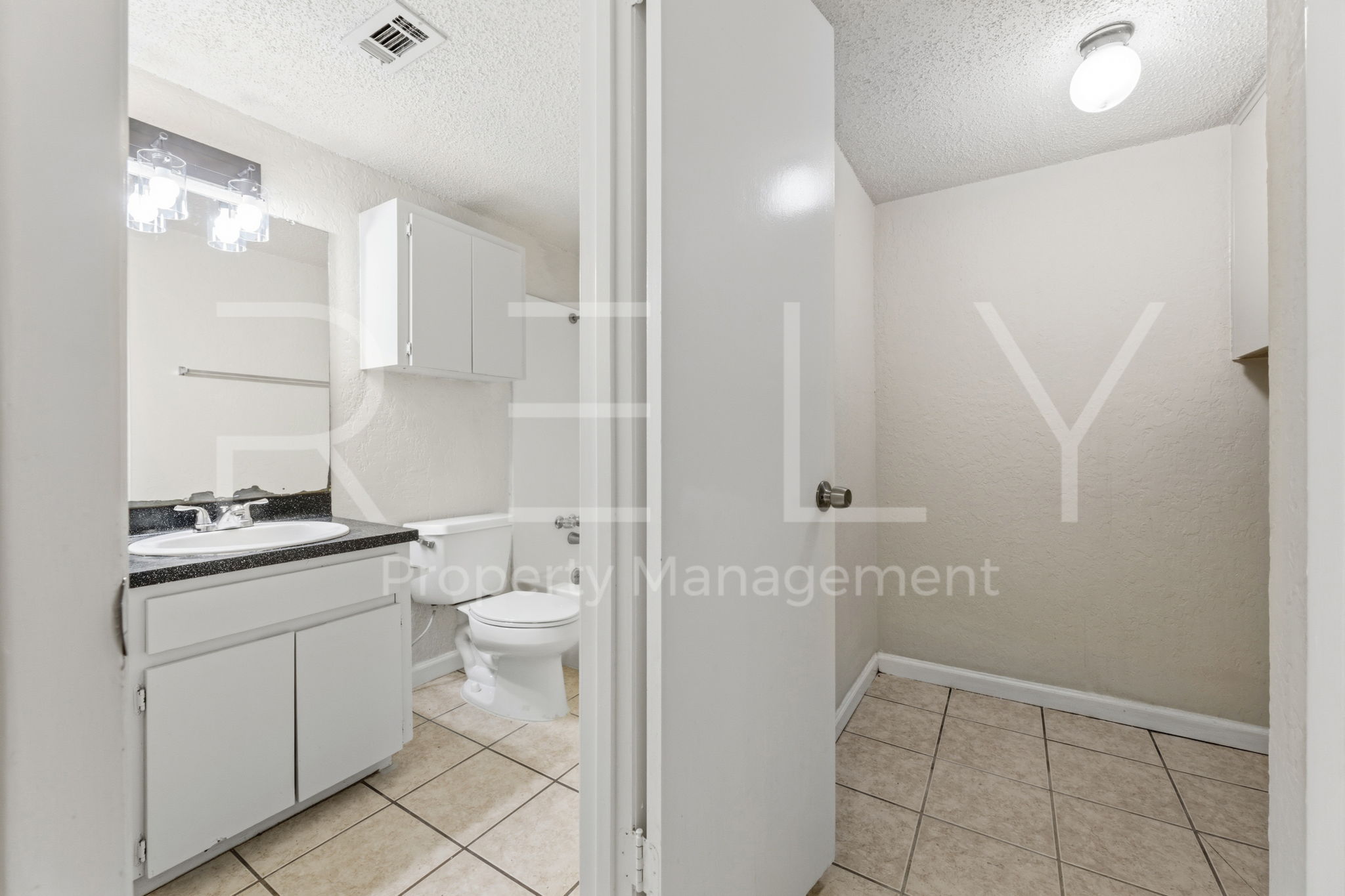 1005 Milford Way, Unit A Austin, TX 78745 - Photo 18 of 30 a bathroom with a granite countertop sink a toilet and a shower