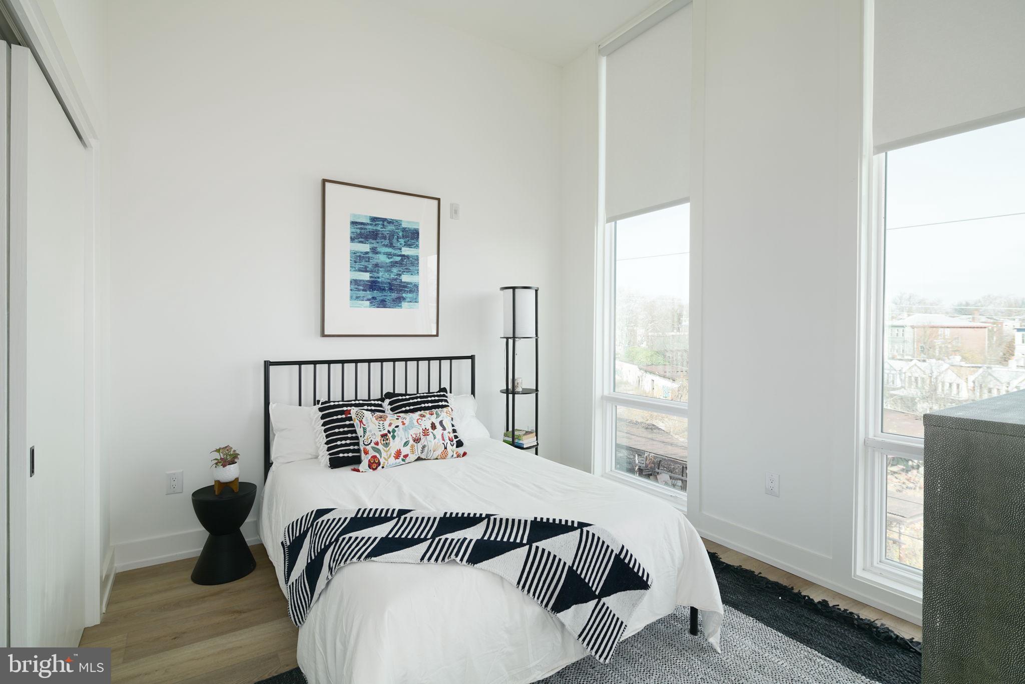 5013 Springfield Avenue, Unit 406 Philadelphia, PA 19143 - Photo 11 of 17 a bedroom with a bed and a window