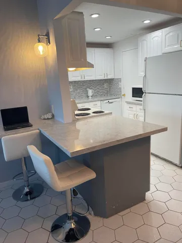 a kitchen with a sink cabinets and window