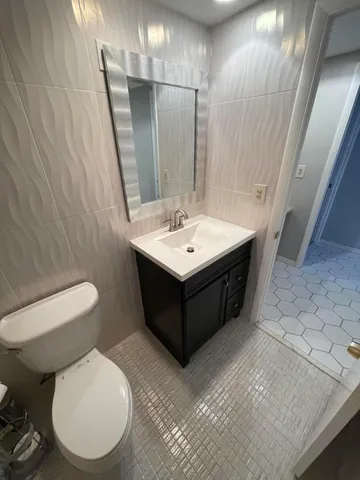 a bathroom with a sink toilet and mirror