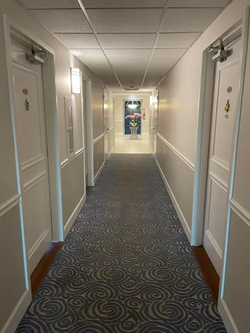 a view of hallway with wooden floor
