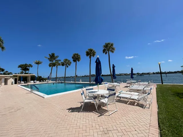 a view of swimming pool with outdoor seating