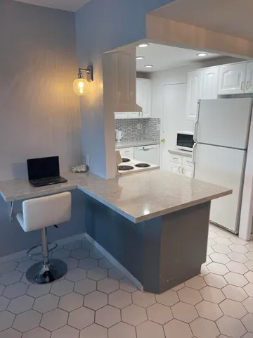 a kitchen with counter top space and appliances